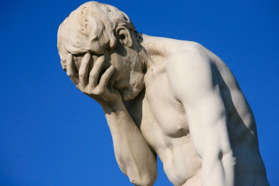 statue showing a facepalm